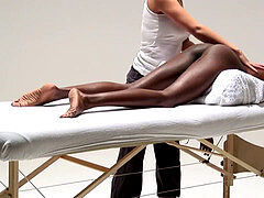 white massagist lubes up and sensually fingers he ebony client