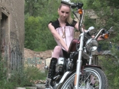 Sweet teen is amazed by a large bike