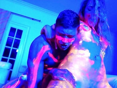 Covered with neon paint lovelies have group sex in blue light